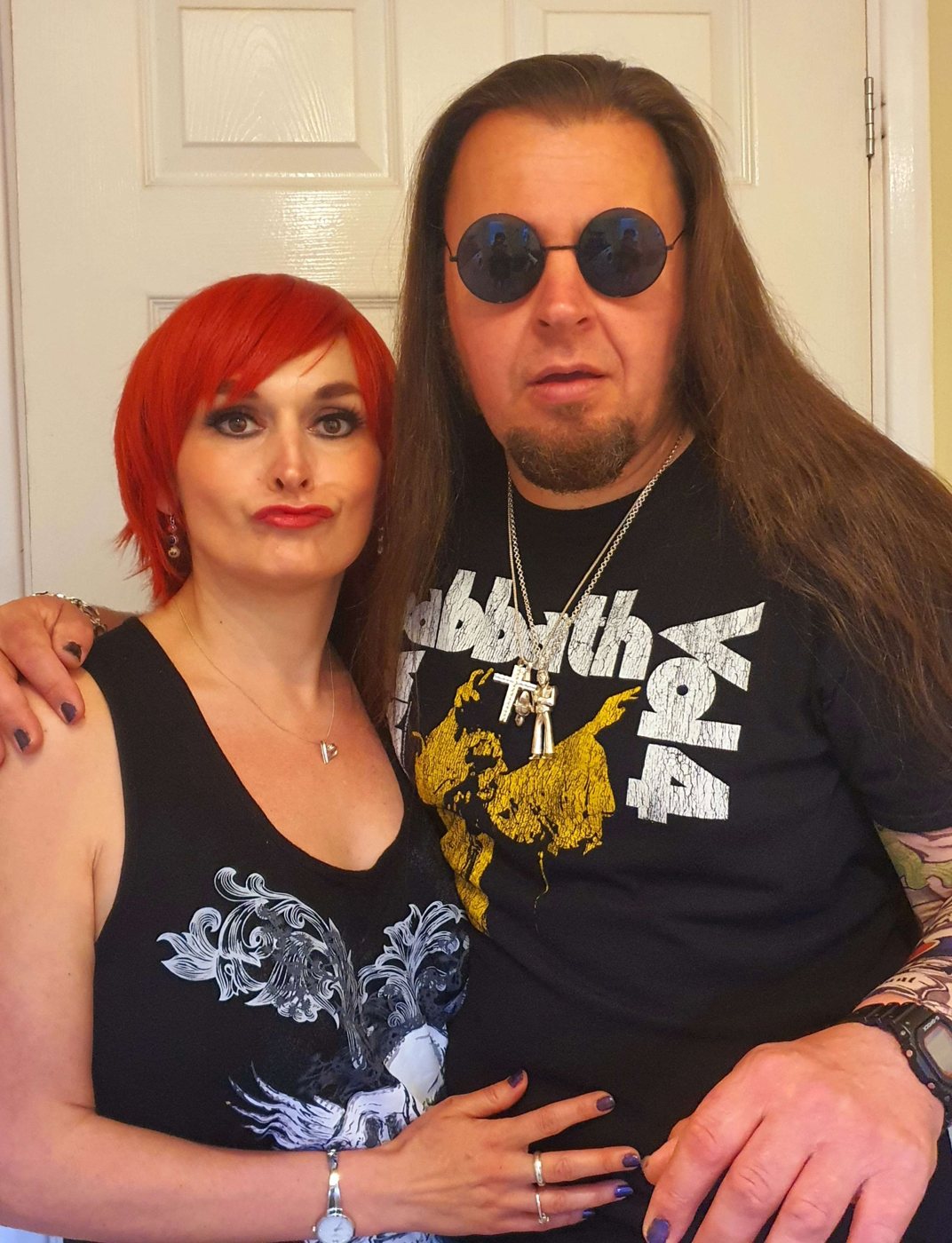 KingBushCamp in round sunglasses and a Black Sabbath T-shirt